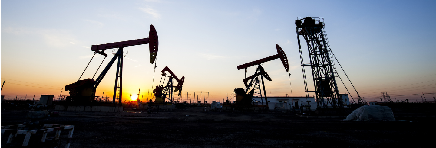 Oil gas rigs at sunset.